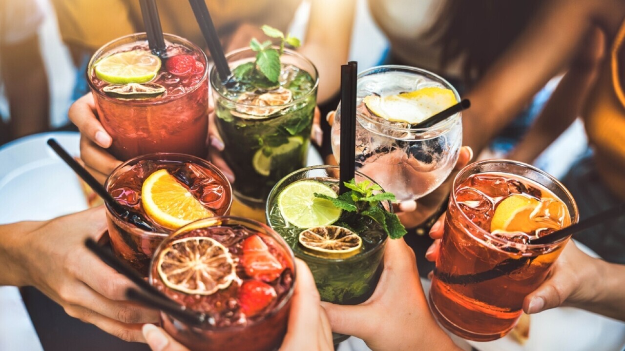 Stock image of people holding various cocktails.