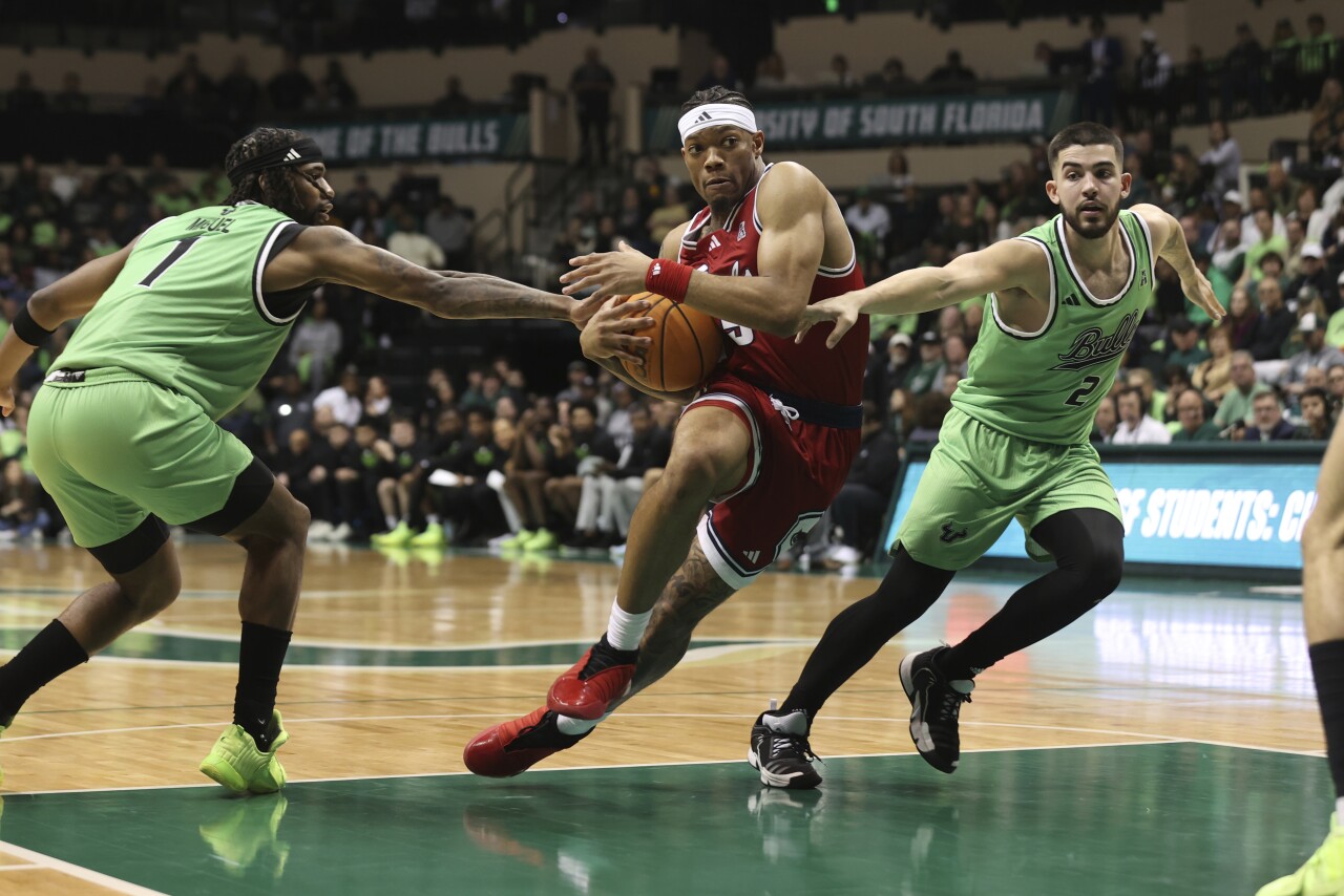 Florida Atlantic Owls guard Alijah Martin drives to basket between South Florida Bulls guards Selton Miguel and Jose Placer, Feb. 18, 2024