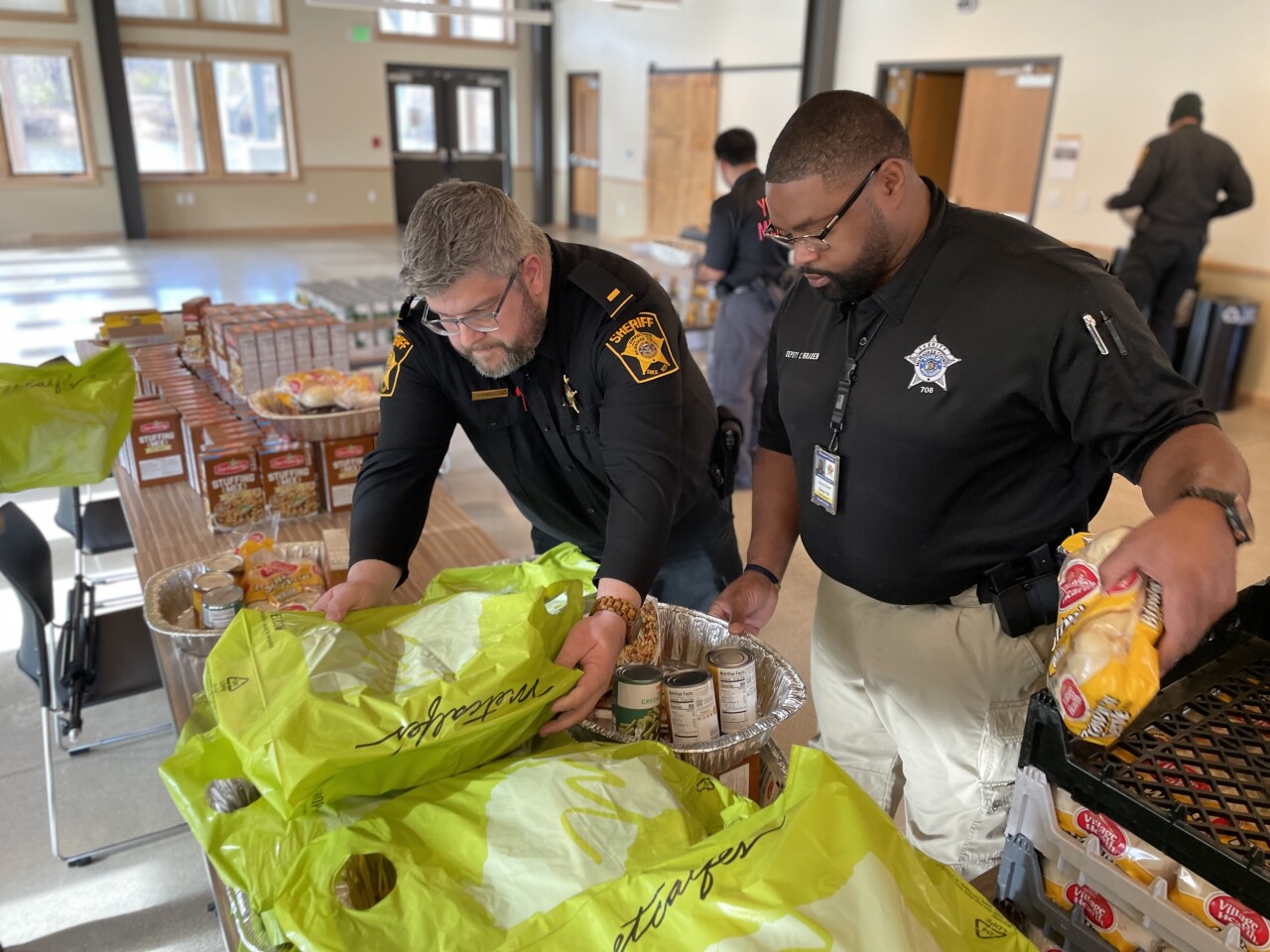 At the Urban Ecology Center in Washington Park, deputies worked an assembly line to prepare complete holiday meals as part of a tradition nearly a decade strong
