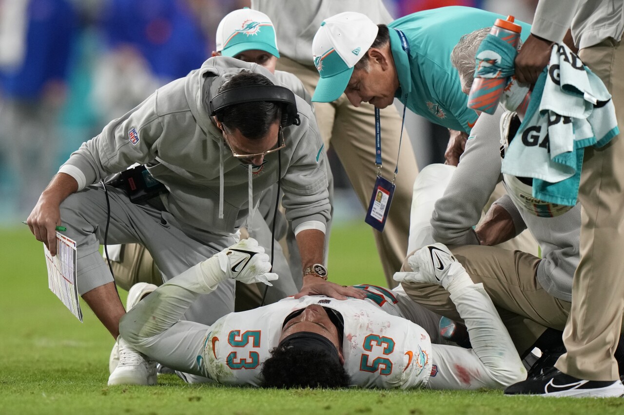 Miami Dolphins head coach Mike McDaniel and defensive coordinator Vic Fangio check on linebacker Cameron Goode after injury in second quarter of 'Sunday Night Football' game, Jan. 7, 2024
