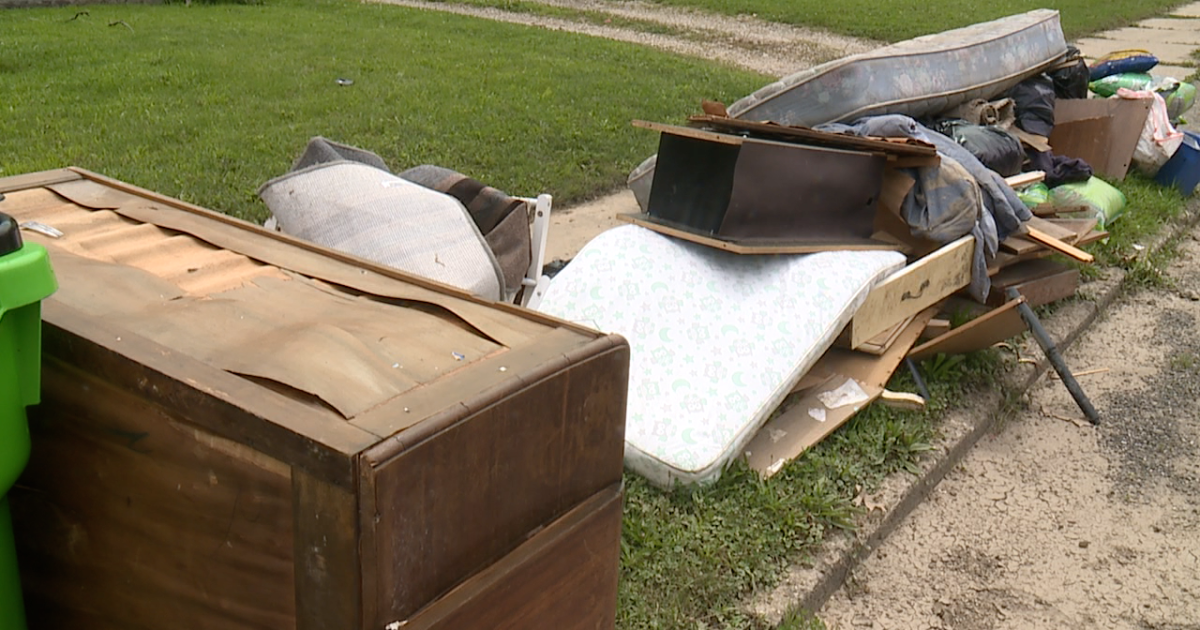 After flooding, neighbors clean up and hope for assistance