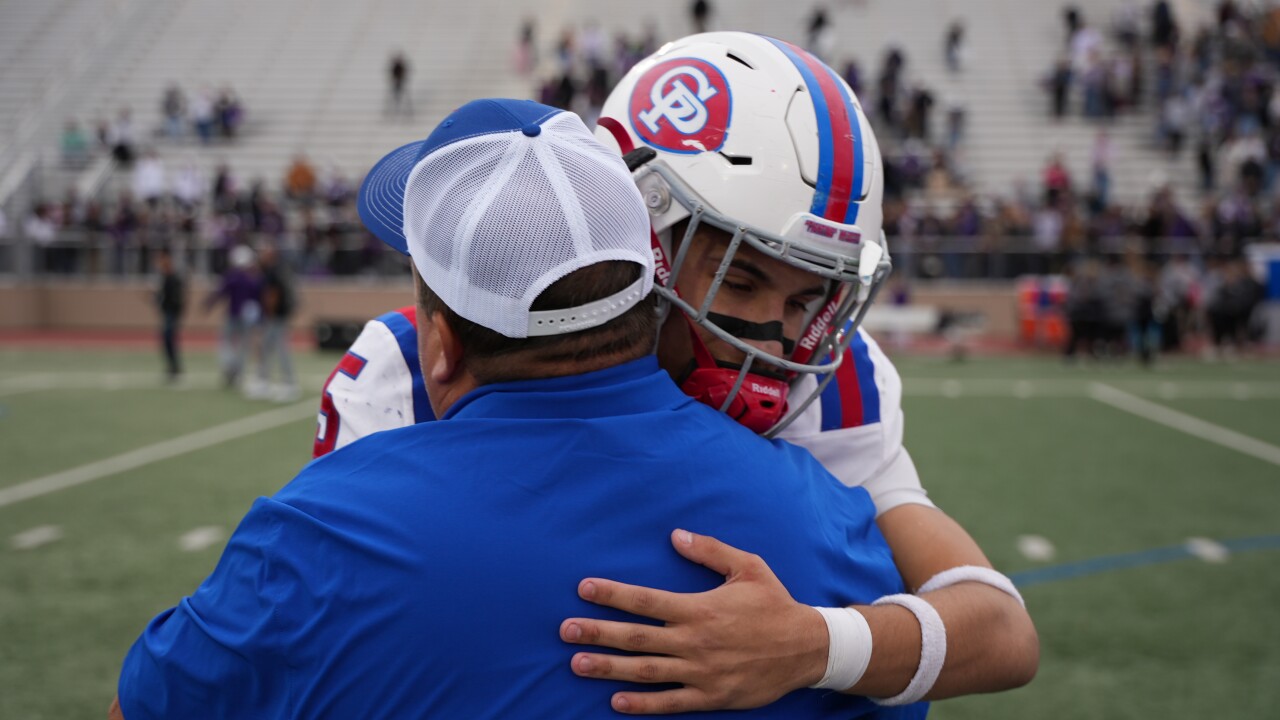Gregory-Portland senior running back Cody Adame hugs a coach