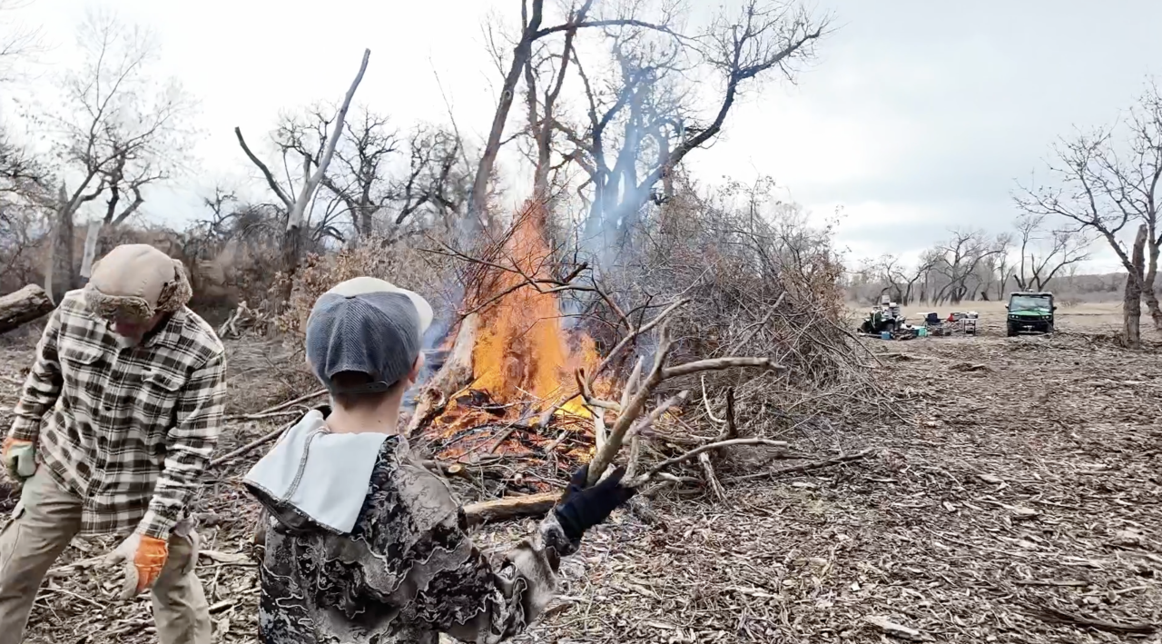 Weston throwing debris into the fire