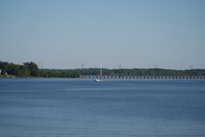 A boat riding in front of the Bush River Bridge