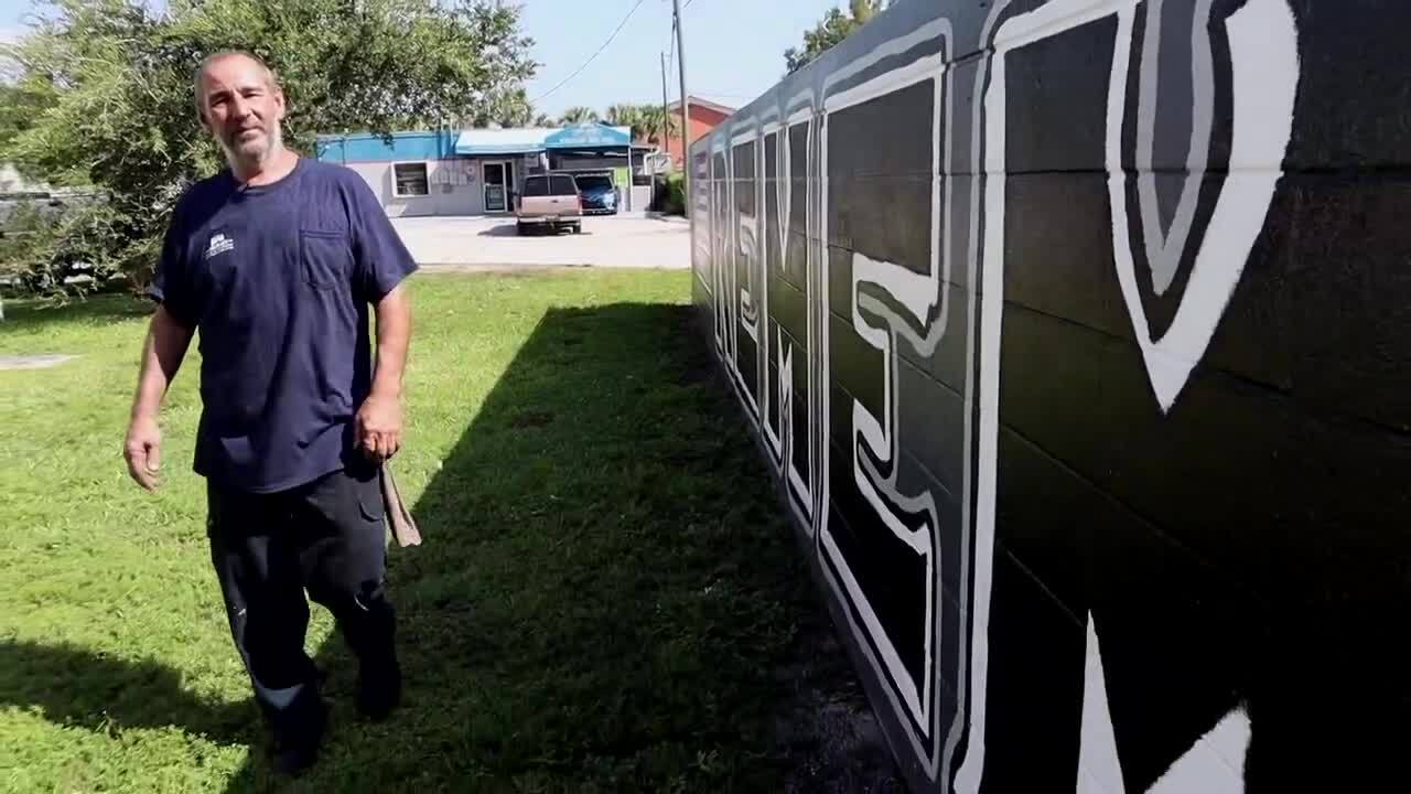 Jeff Lunin walks along 9/11 wall mural
