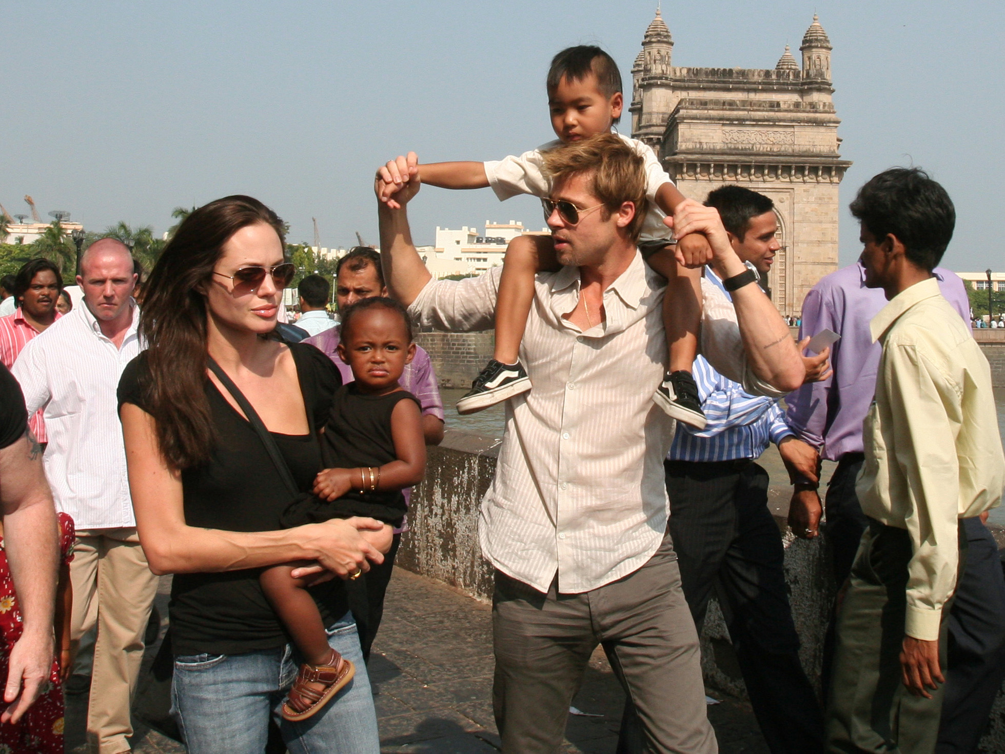 FILE - Actress and UNHCR Ambassador Angelina Jolie, left, with daughter Zahara, and Brad Pitt, second right, with son Maddox, walk near the Gateway of India, in background, in Mumbai, India, on Nov. 12, 2006.