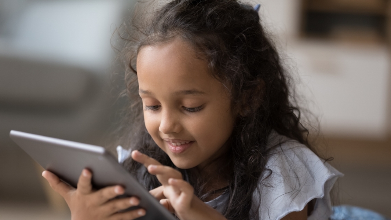 A child playing on a tablet.