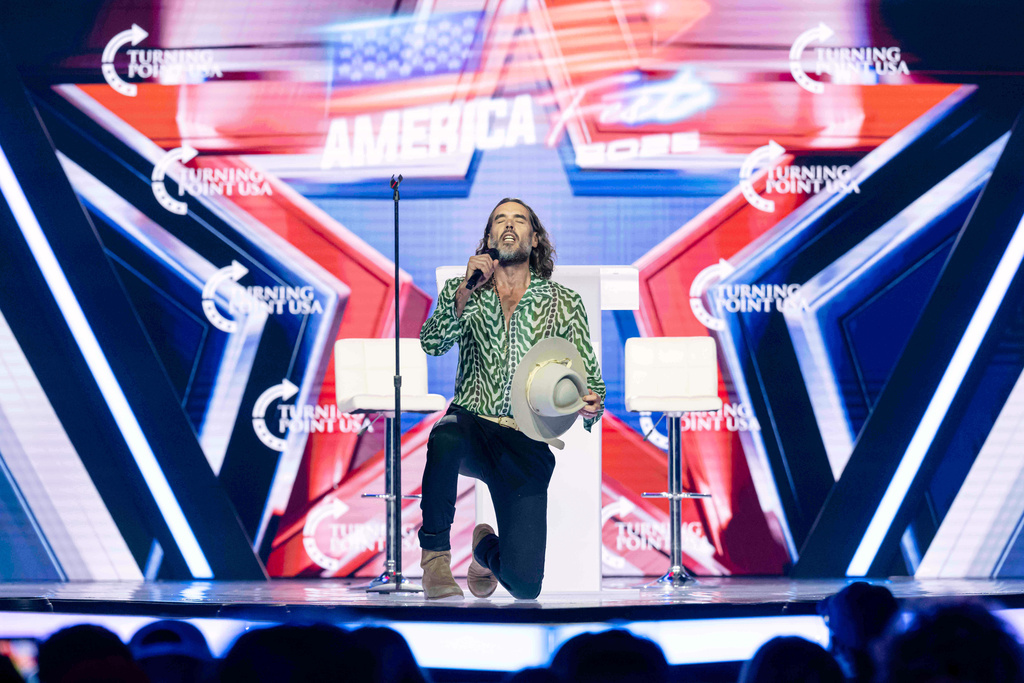 Russell Brand speaks during Turning Point USA's AmericaFest 2025, Thursday, Dec. 18, 2025, in Phoenix.