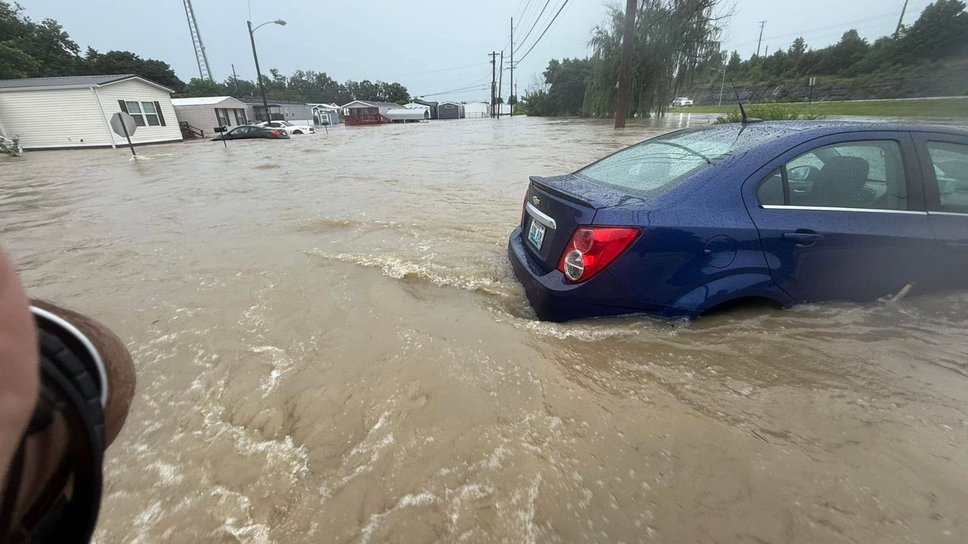 Floodwaters cover roads in Richmond, Kentucky, on June 27, where emergency responders have performed water rescues and blocked off flooded roadways.