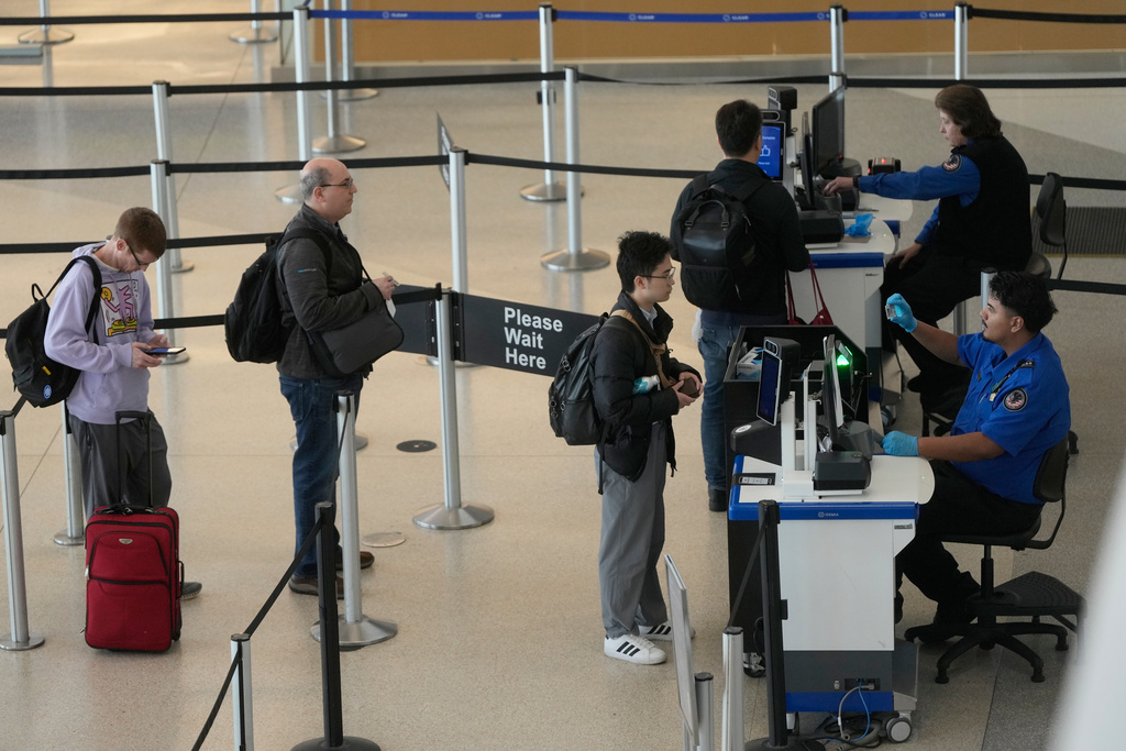 Covenant Aviation Security Private Security Services agents check in passengers at a security gate at San Francisco International Airport in San Francisco, Friday, Feb. 27, 2026.