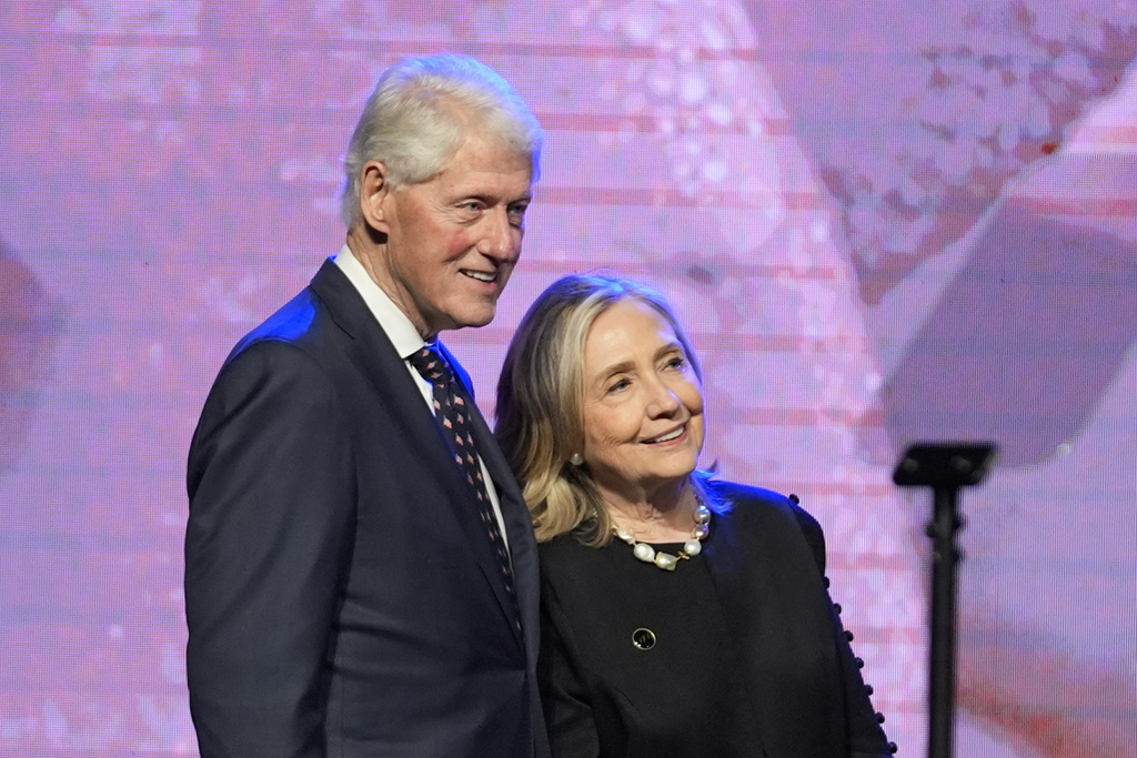 Former President Bill Clinton, left, and former Secretary of State Hillary Clinton listen as Vice President Kamala Harris delivers a eulogy for U.S. Rep. Sheila Jackson Lee, Thursday, Aug. 1, 2024, in Houston. 