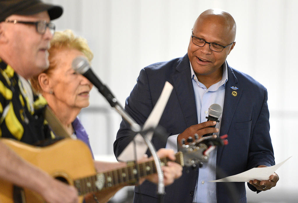 Democratic candidate Shawn Harris, right, sings along with a song written about his campaign during a barbecue at the Chattanooga County Agricultural Center, in Summerville, Ga., Tuesday, Sept. 24, 2024. 