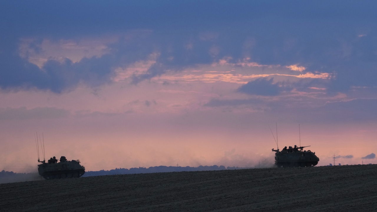 A convoy of Israeli armoured personnel carriers head towards the Gaza Strip border in southern Israel