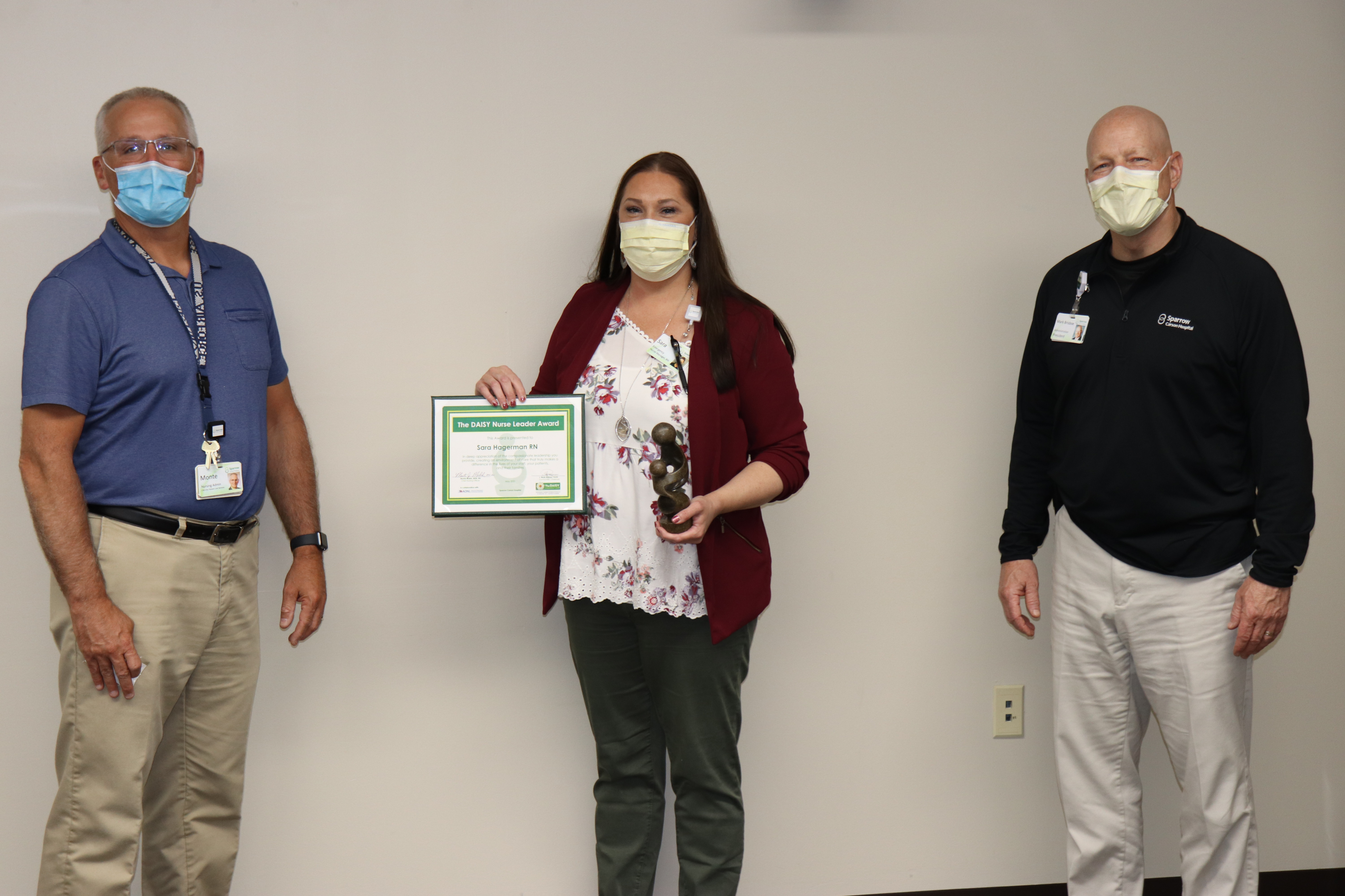 Sara Hagerman receives Daisy Nursing Award from Monte Malek and Mark Brisboe