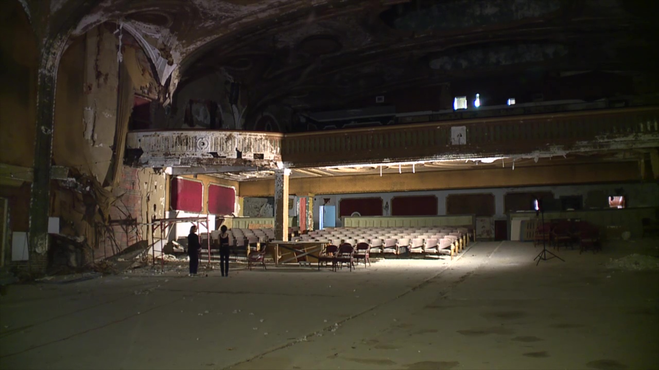 Owner Kelly Flamos, right, and News 5 reporter Michelle Jarboe stand inside the long-empty Variety Theatre on Cleveland's West Side.