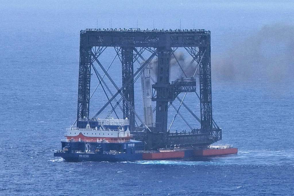 In this photo released by Xinhua News Agency, a drone photo shows the successful capture of the returned first stage of Long March-10B carrier rocket on a seaborne platform via a net-capture system near Wenchang in southern China's Hainan province on Friday, July 10, 2026. 