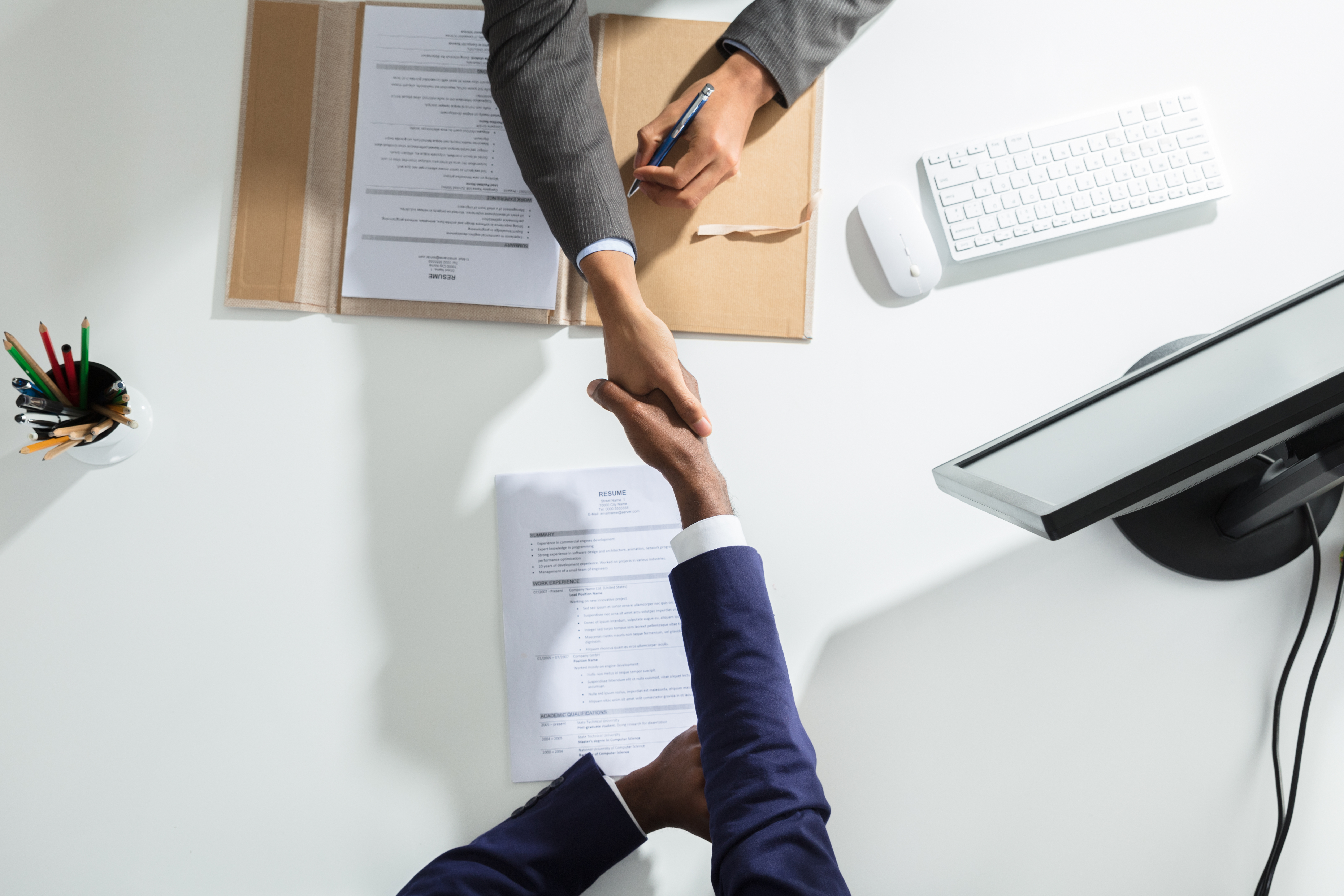 High,Angle,View,Of,Businessperson,Shaking,Hand,With,Candidate,Over