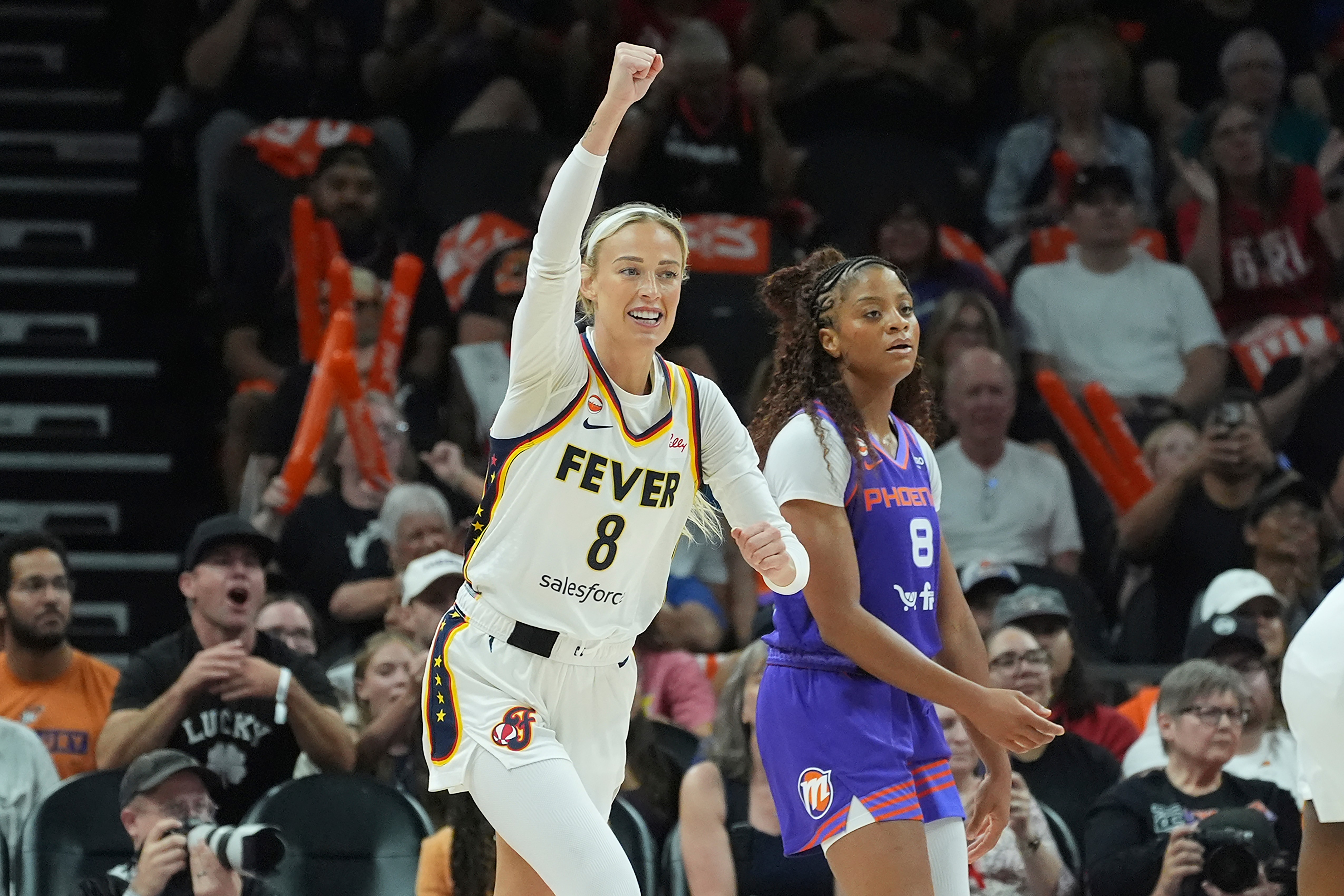 Indiana Fever guard Sophie Cunningham (8) celebrates a score as Phoenix Mercury guard Monique Akoa Makani (8) pauses on the court during the second half of a WNBA basketball game, Thursday, July 9, 2026, in Phoenix. 