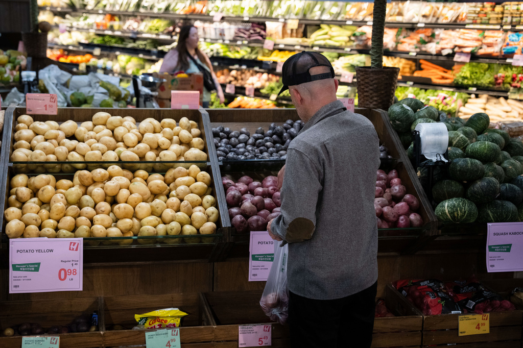 Customers shop in the produce section of a grocery store on Monday, May 11, 2026, in Portland, Ore. 