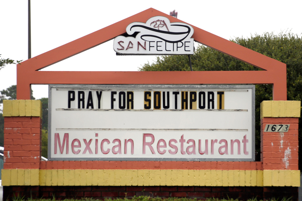 A sign on a Mexican restaurant asks people to "Pray for Southport," following a fatal shooting that occurred at he American Fish Company in the town the night before, Sunday, Sept. 28, 2025, in Southport, N.C.