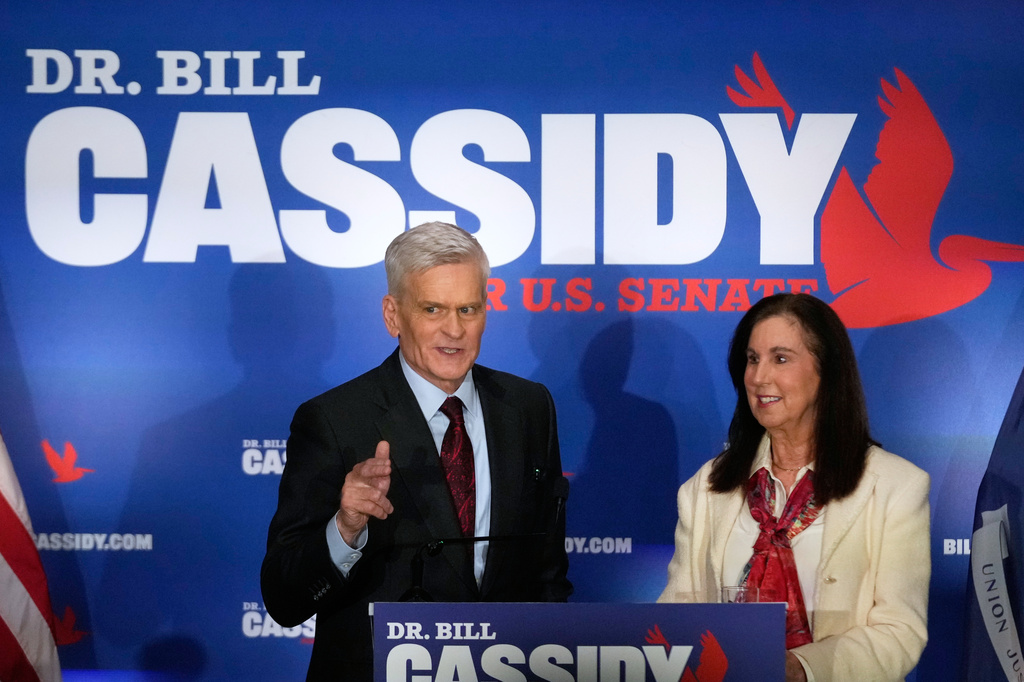 Sen. Bill Cassidy, R-La., left, speaks to supporters alongside his wife, Laura, during an election night watch party.