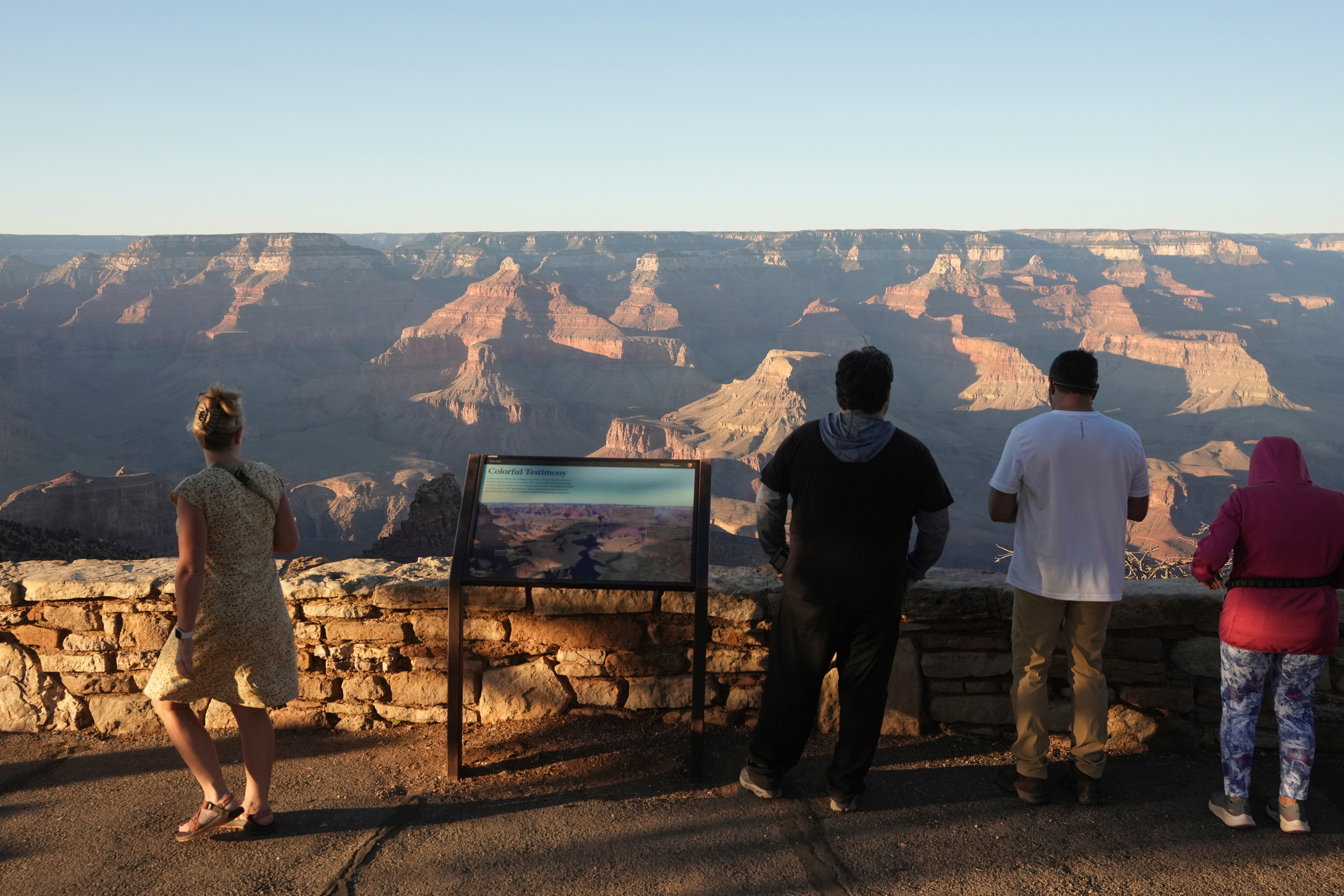 Visitors pause along the Rim Trail at Grand Canyon National Park on the first day of the government shutdown Wednesday, Oct. 1, 2025, in Grand Canyon, Ariz. 