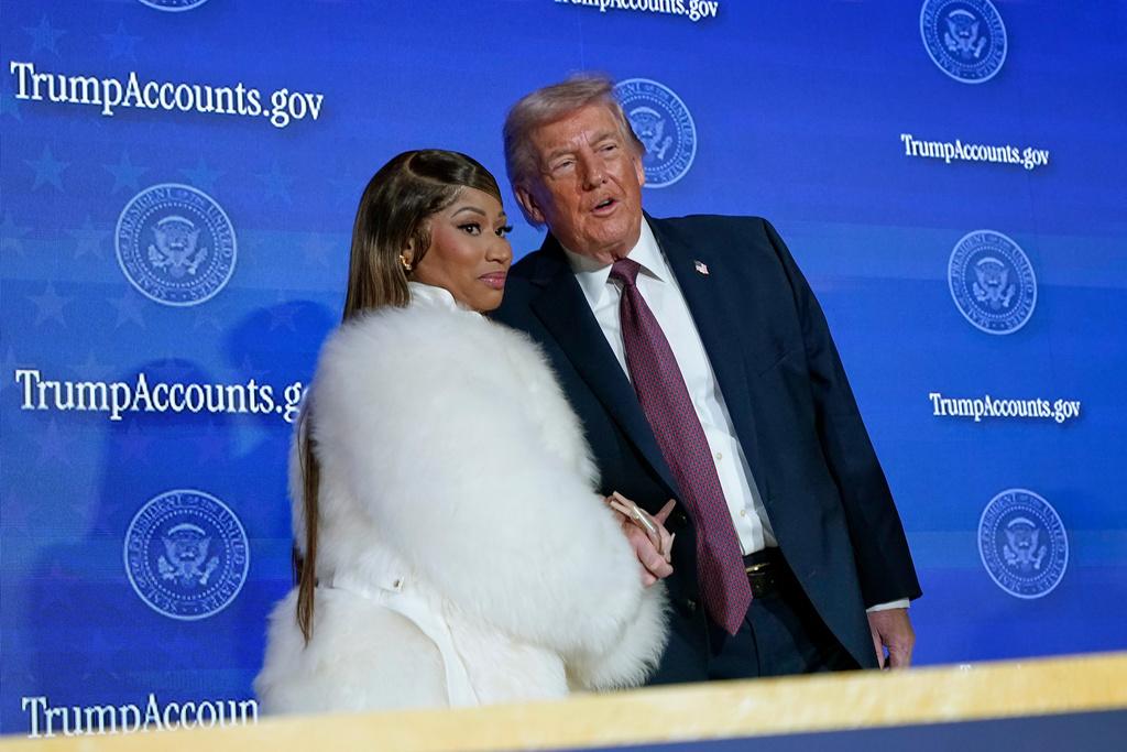 Nicki Minaj and President Donald Trump hold hands on stage during the launch of a program known as Trump Accounts at the Andrew W. Mellon Auditorium, Wednesday, Jan. 28, 2026, in Washington.