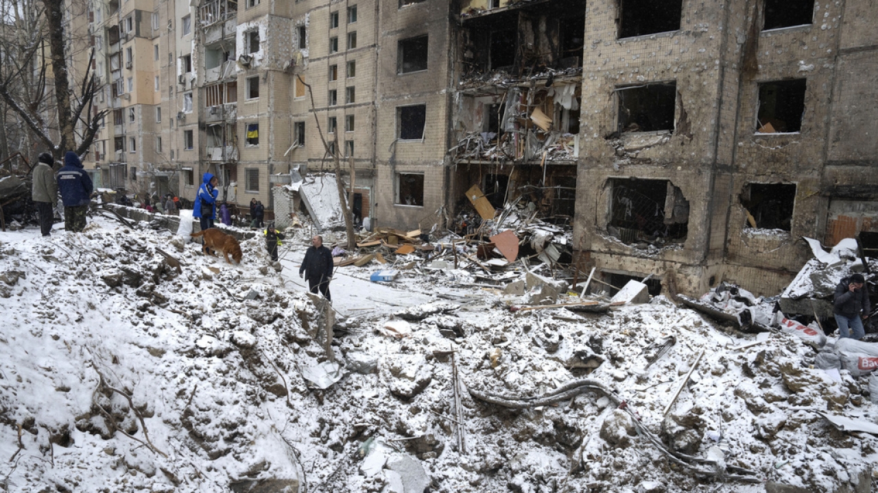 A crater next to a Ukrainian apartment building following a Russian attack.