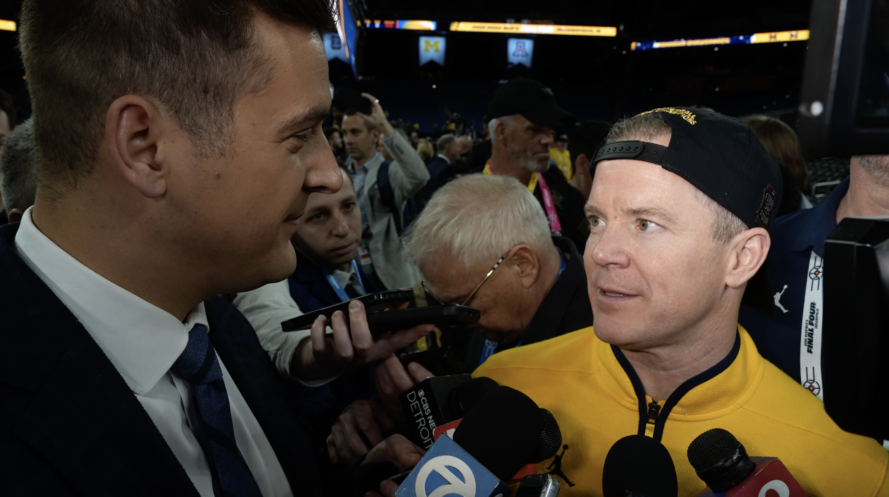 Dusty May talks with Brad Galli at Michigan national championship celebration