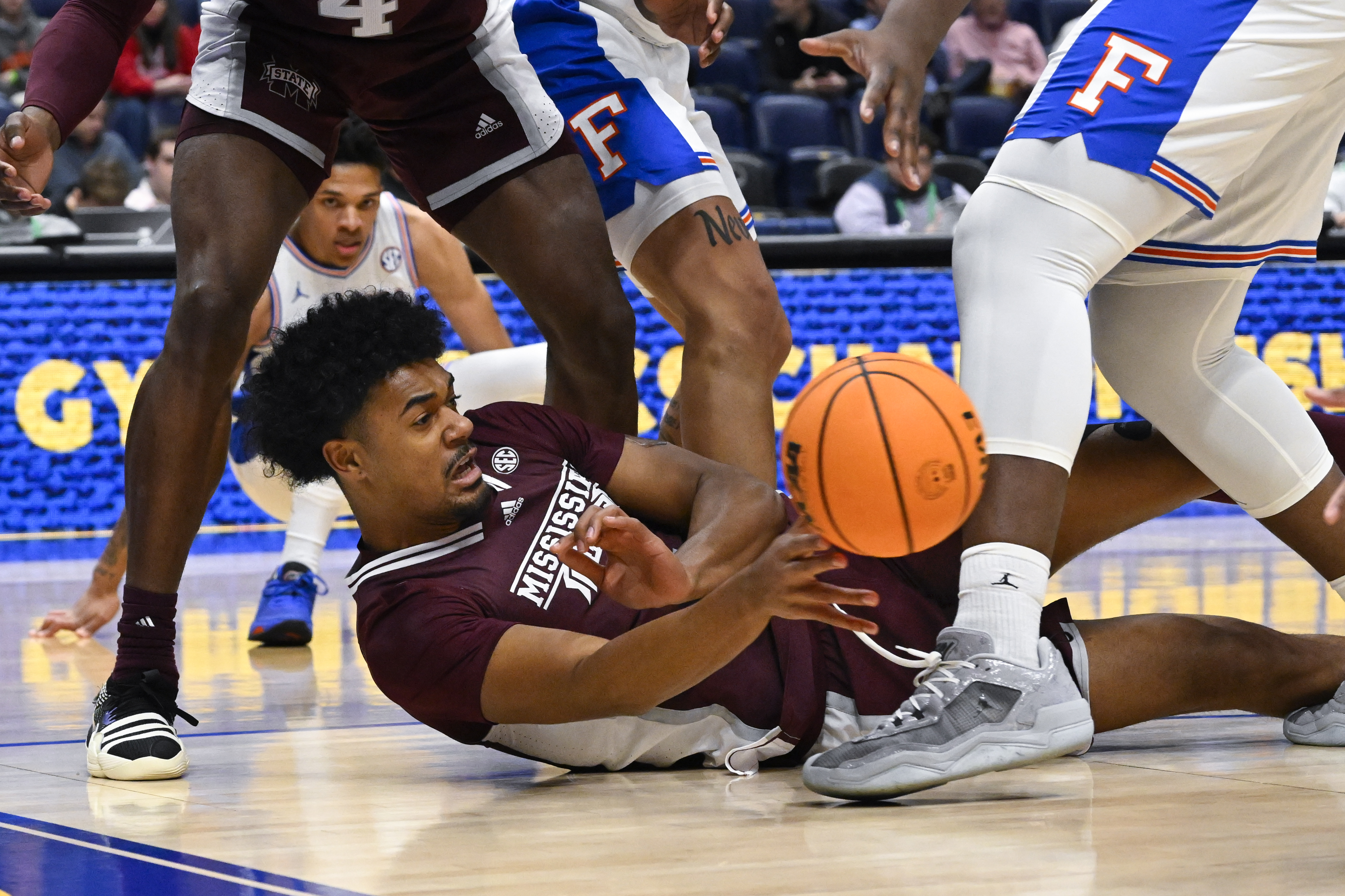 Mississippi Smith Bulldogs forward Tolu Smith passes on ground against Florida Gators in 2023 SEC Tournament