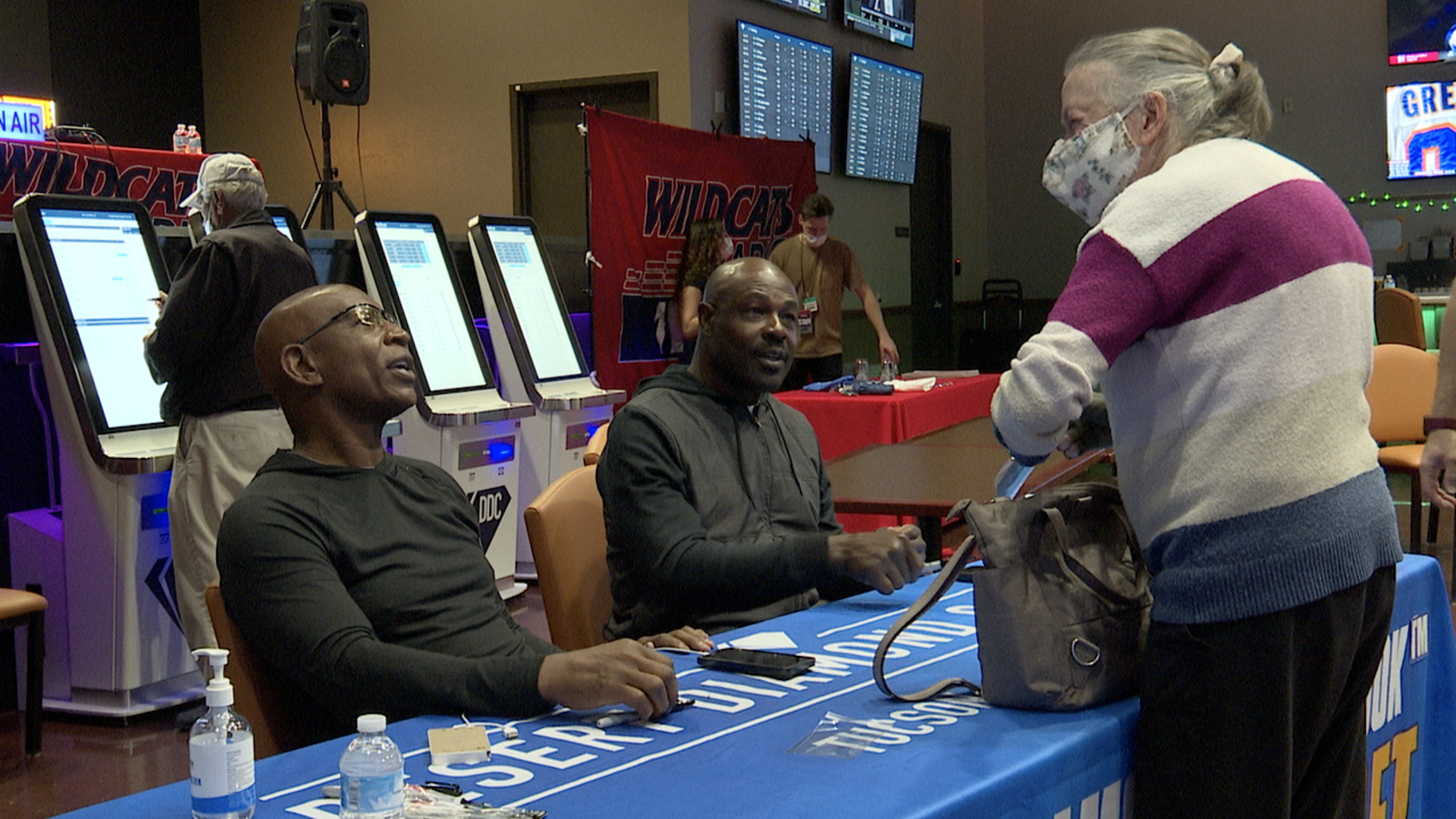 Eric Dickerson and Christian Okoye greet fans at the Desert Diamond Casino sportsbook in Sahuarita.