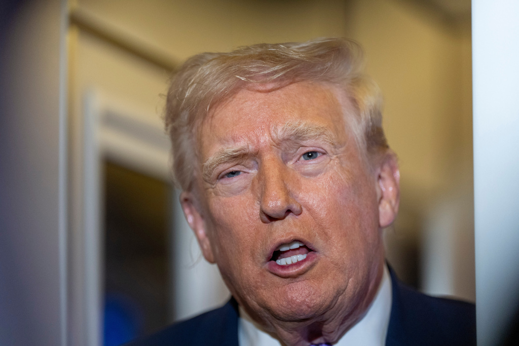 President Donald Trump speaks with reporters while in flight on Air Force One from his Mar-a-Lago estate in Palm Beach, Fla., to Joint Base Andrews, Sunday, Nov. 30, 2025.
