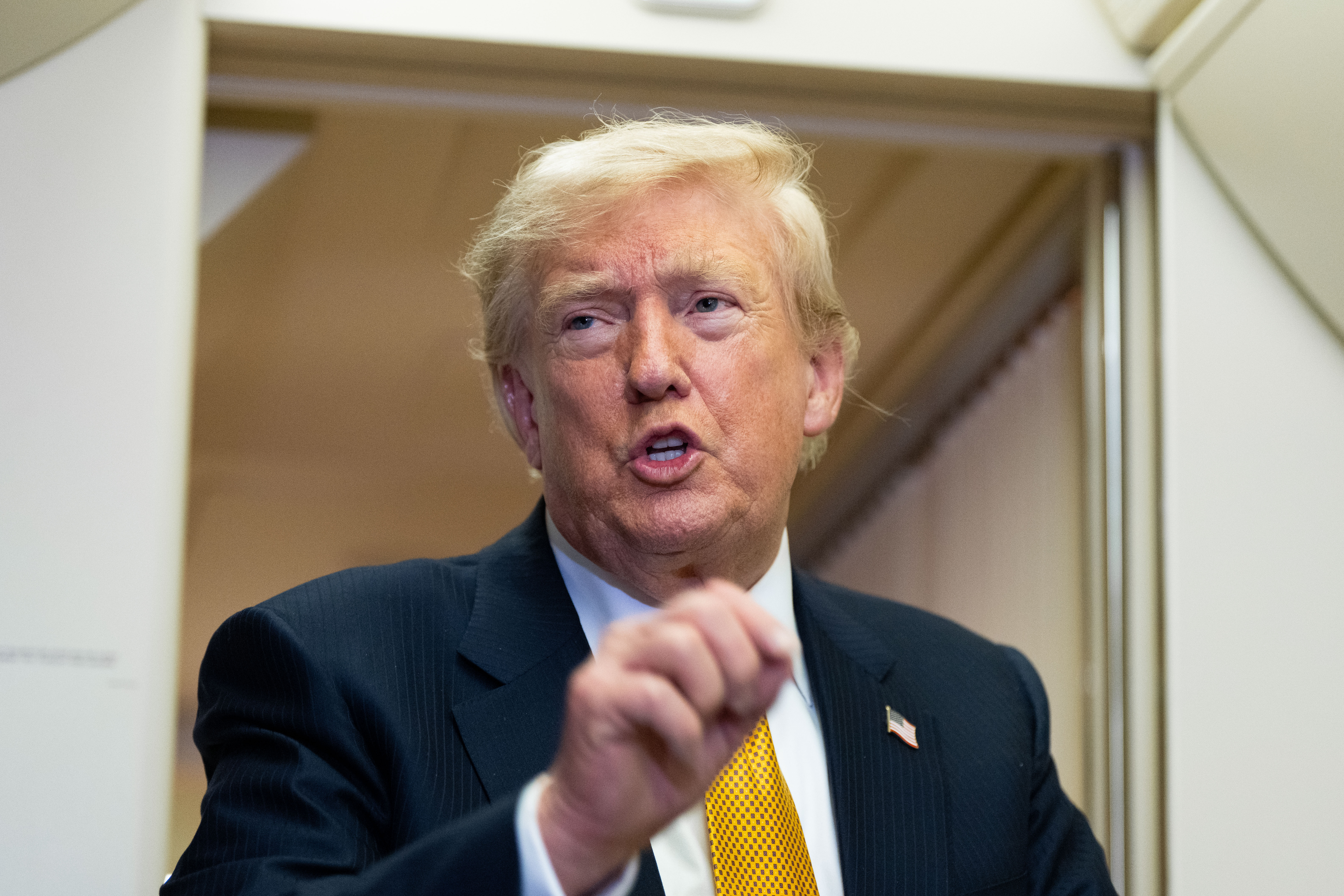 President Donald Trump speaks with reporters in flight on Air Force One after landing at U.S. Air Force Base at RAF Mildenhall, in Suffolk, Eastern England, Wednesday, July 8, 2026. 