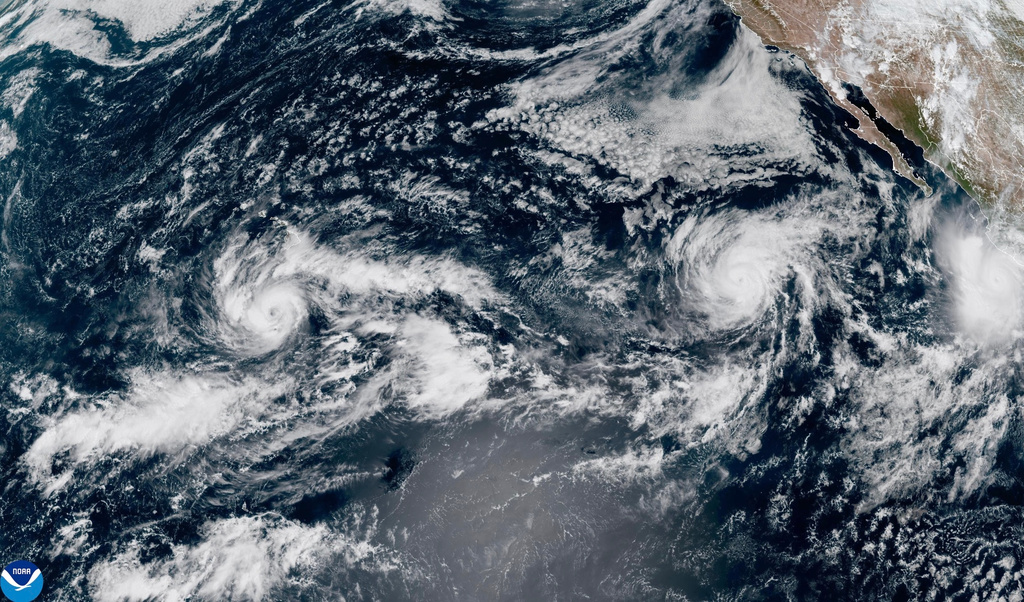 This satellite image provided by NOAA shows Tropical Storm Nolo, left, south of Hawaii; Hurricane Odalys, middle, and Hurricane Polo, right, off the coast of Mexico, in the Pacific Ocean on Thursday, Sept. 24, 2026. 