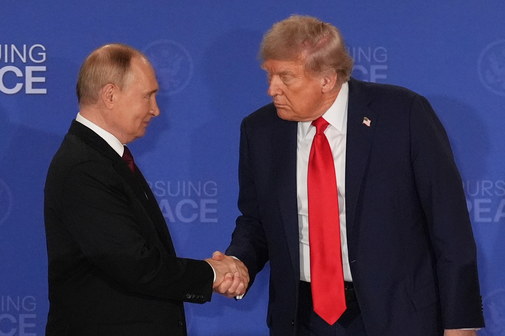 President Donald Trump, right, shakes the hand of Russia's President Vladimir Putin during a joint press conference at Joint Base Elmendorf-Richardson, Alaska.