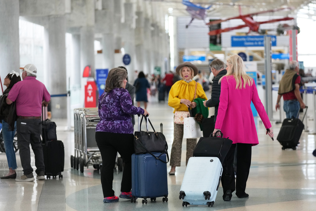 Travelers walk through Terminal 1 at Fort Lauderdale-Hollywood International Airport.