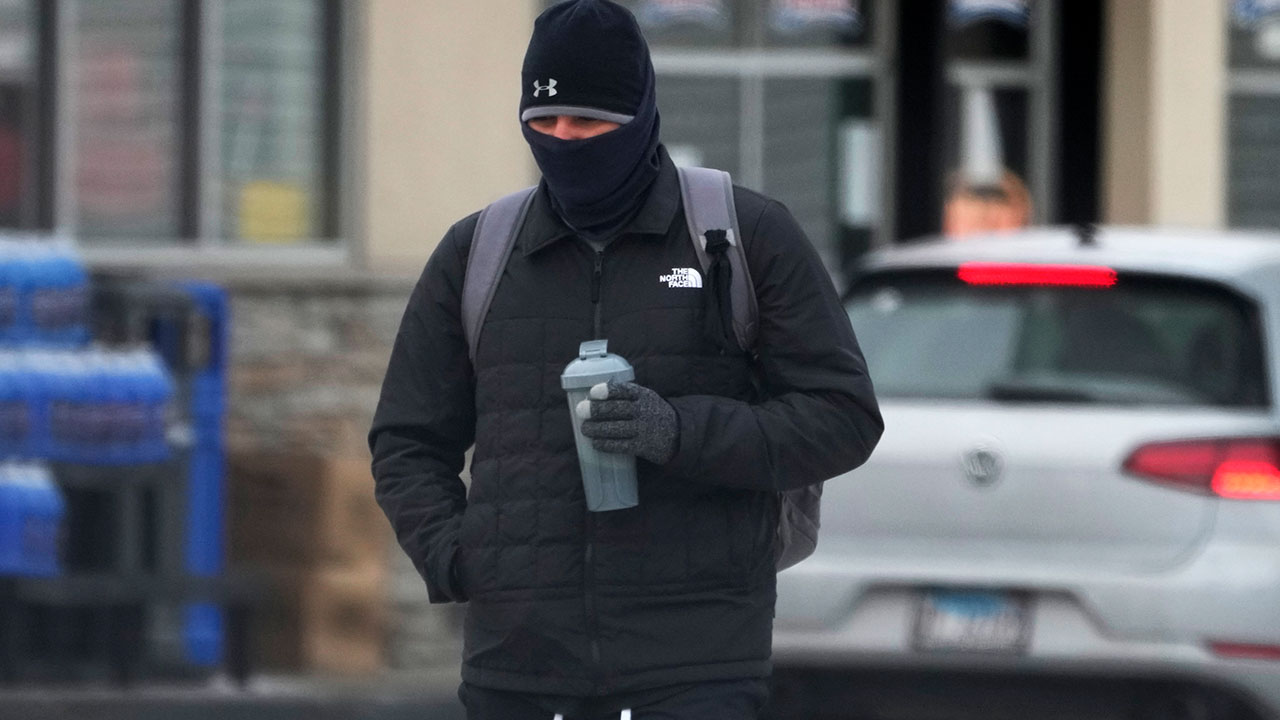 A pedestrian bundles up as he walks on the street during cold weather in Chicago, Wednesday, Jan. 8, 2025. (AP Photo/Nam Y. Huh)
