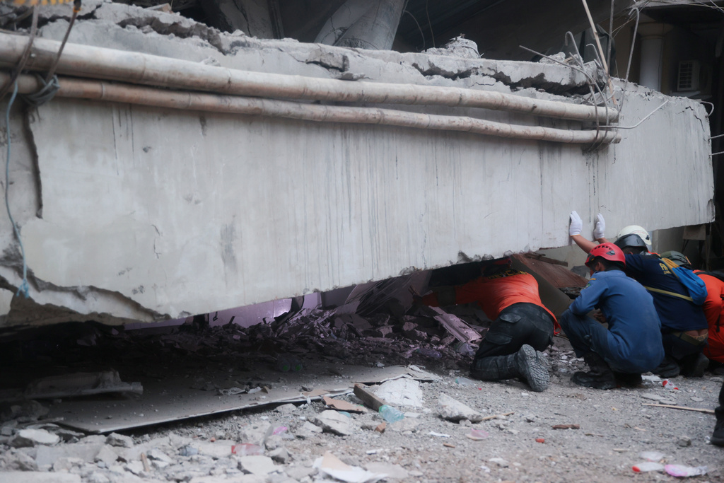 Rescue workers at the site of a collapsed school in Indonesia.