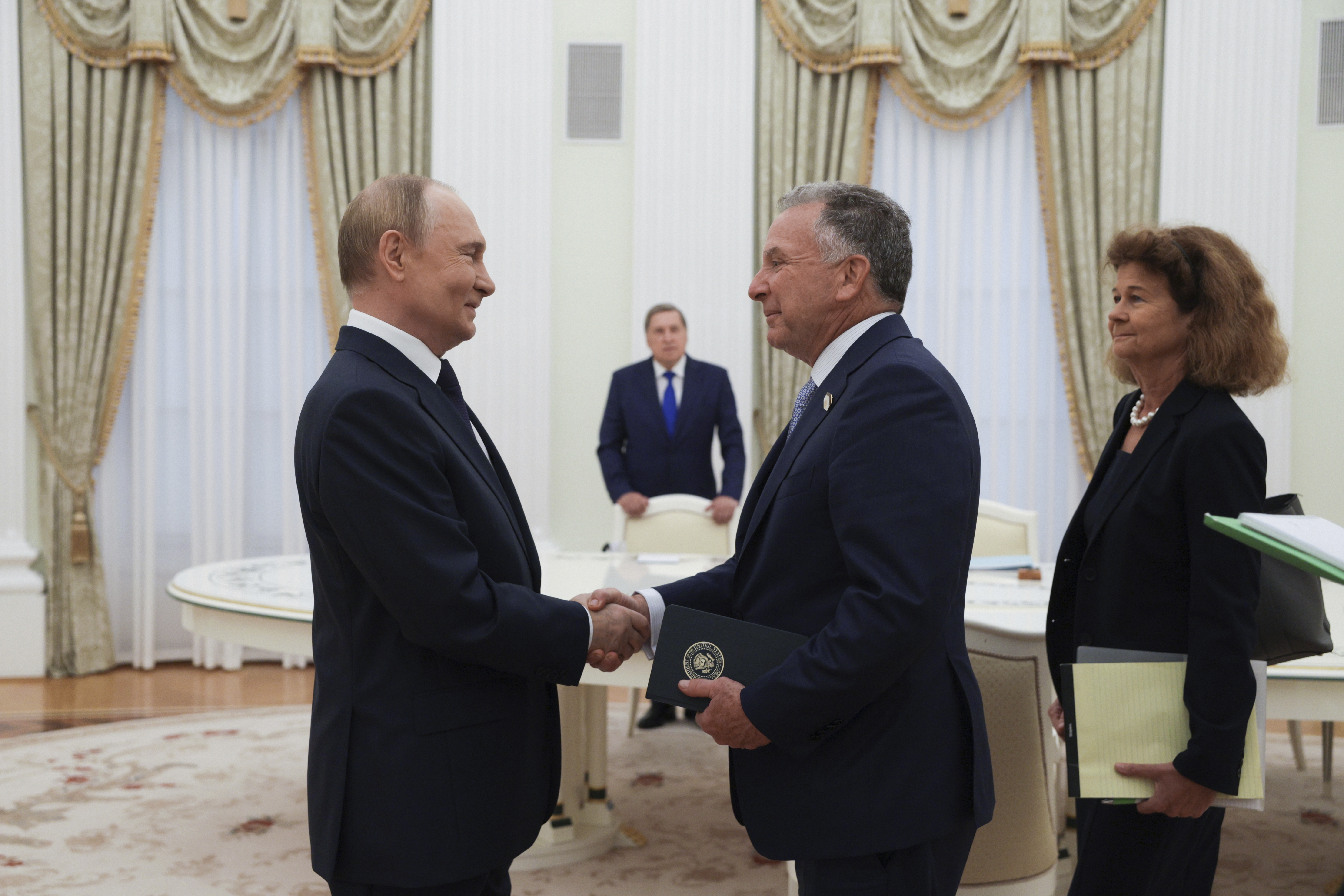 Russian President Vladimir Putin, left, and U.S. President Donald Trump's special envoy Steve Witkoff, right, shake hands during their meeting at the Kremlin in Moscow, Russia, Wednesday, Aug. 6, 2025. 