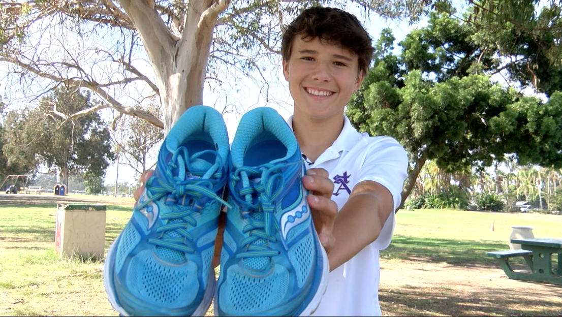 Owen Arnaudy collecting used shoes.png