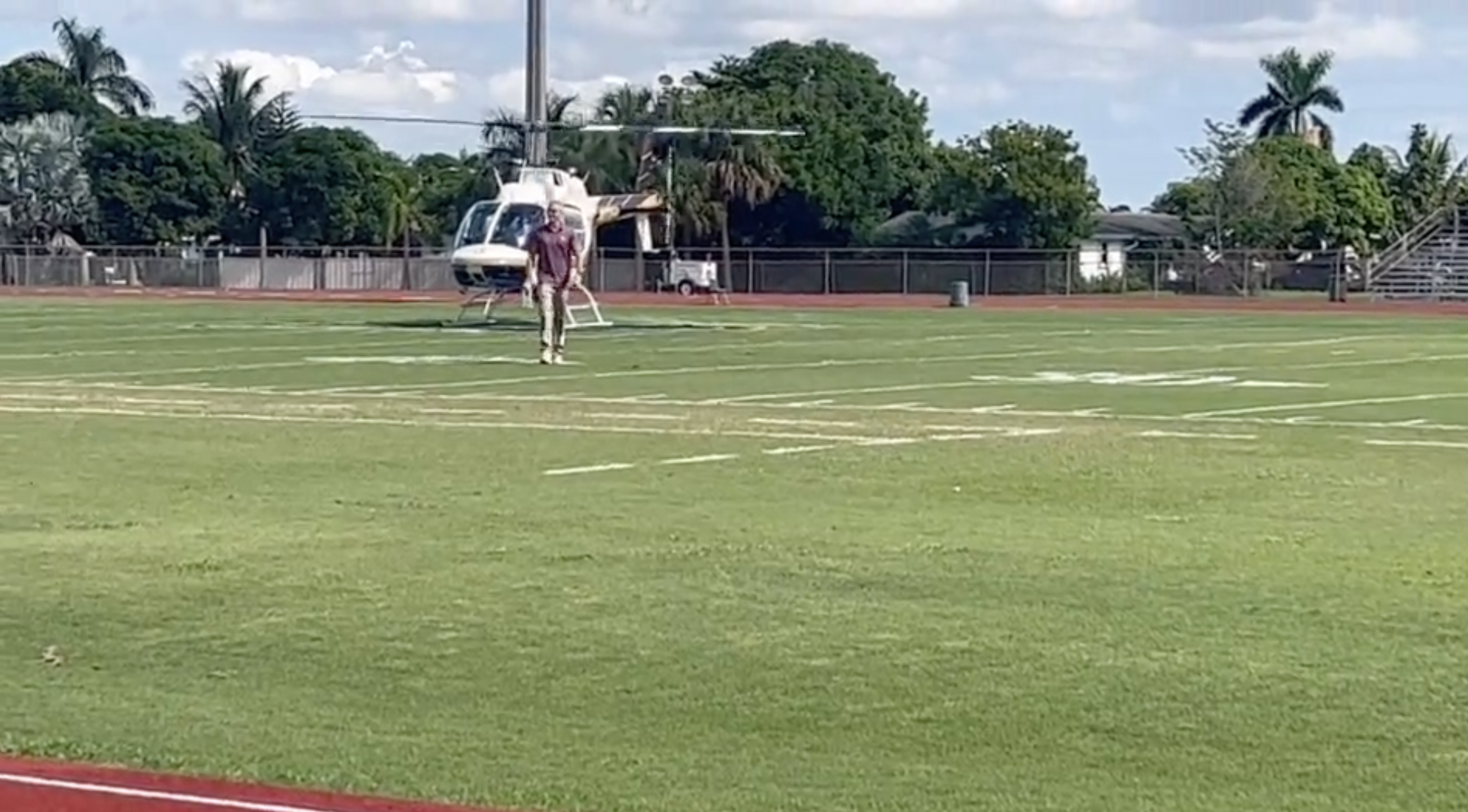 Florida State Seminoles head coach Mike Norvell steps off helicopter on football field at Cardinal Newman High School, Sept. 29, 2023