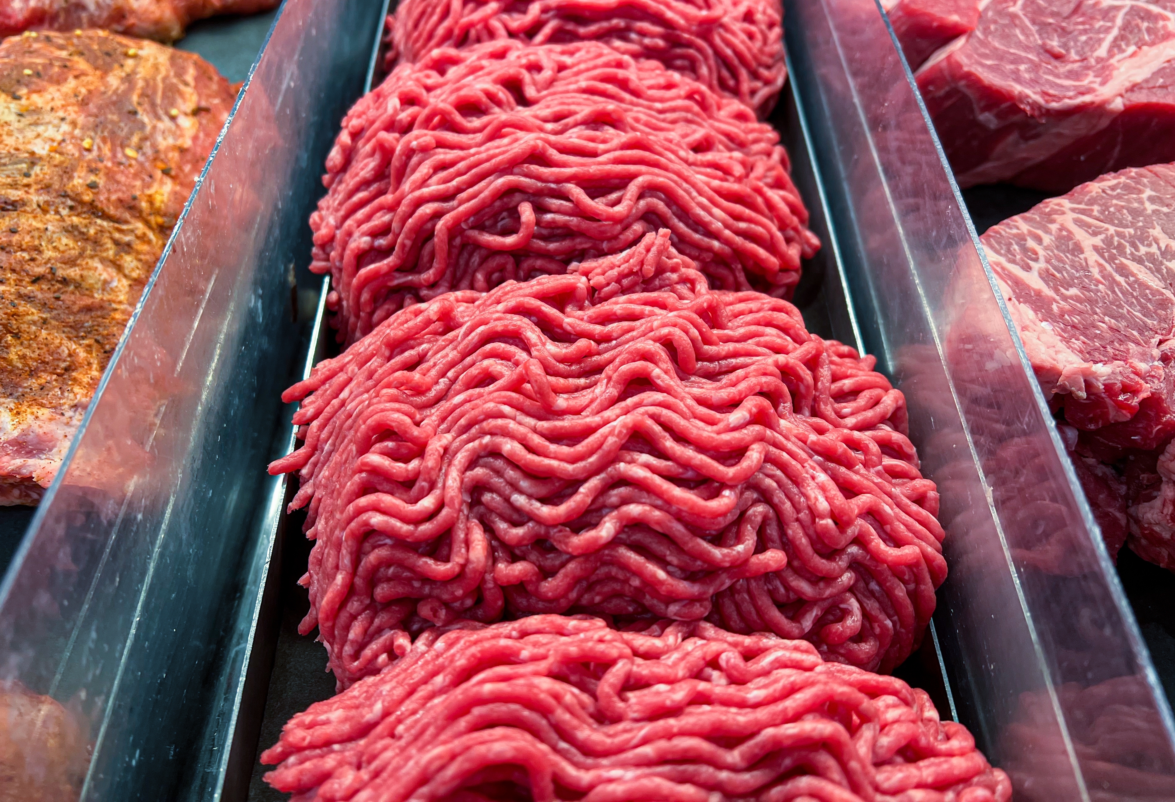 Ground beef in a grocery store case.