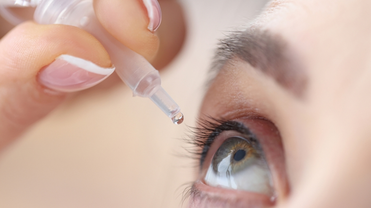 Person using an eye drop.