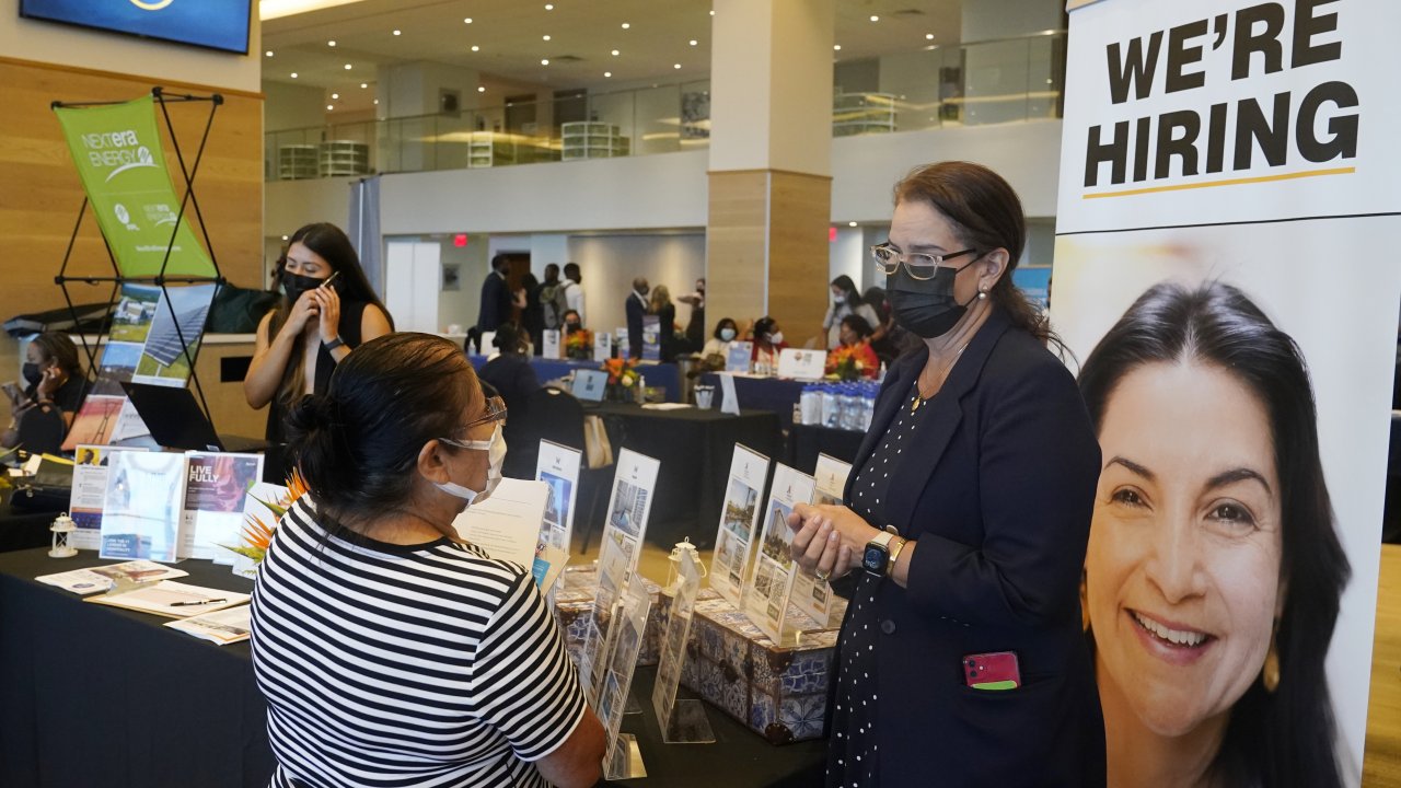 A recruiter talks to a woman at a job fair