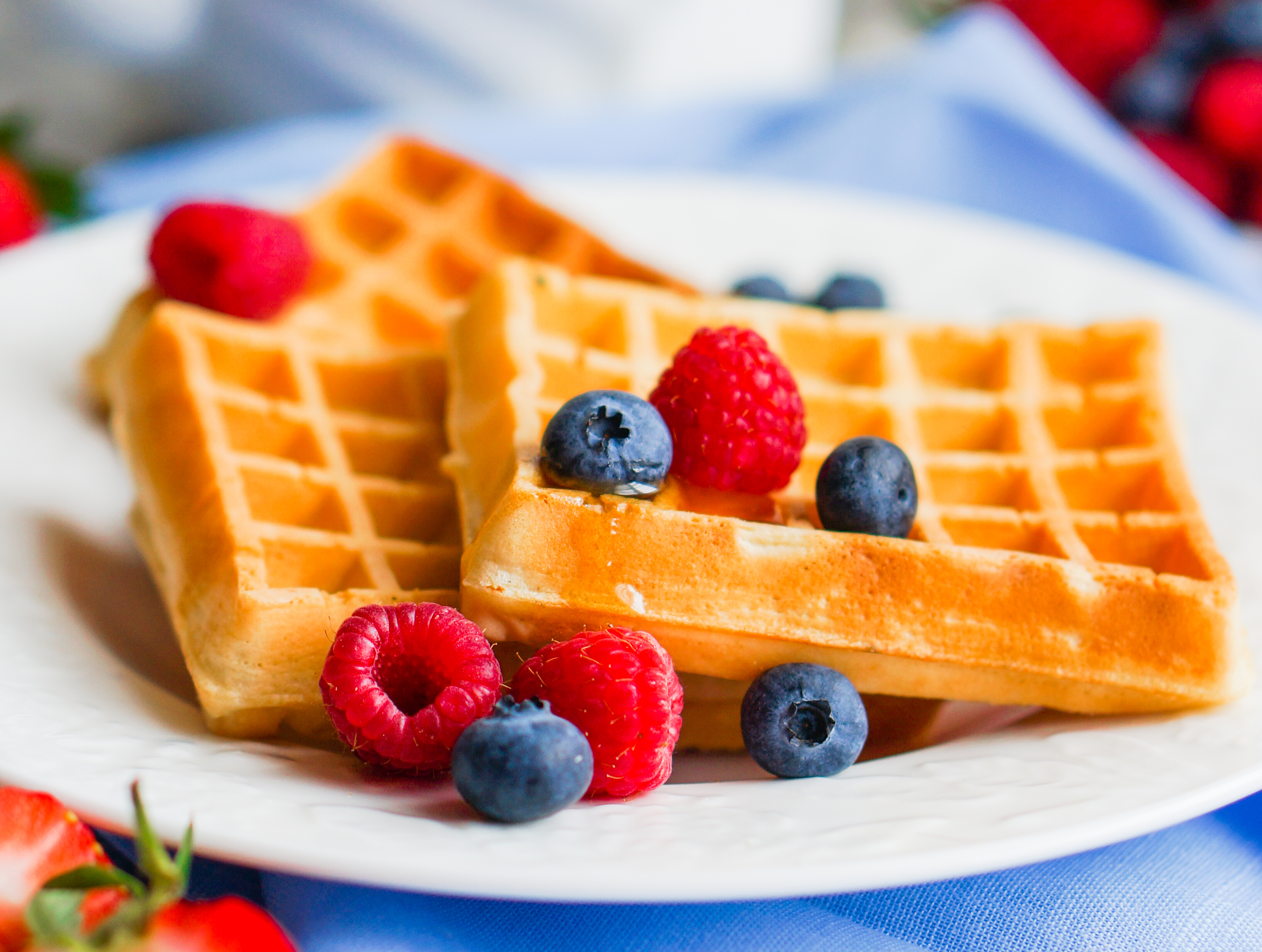 Belgian waffles with berries on rustic background