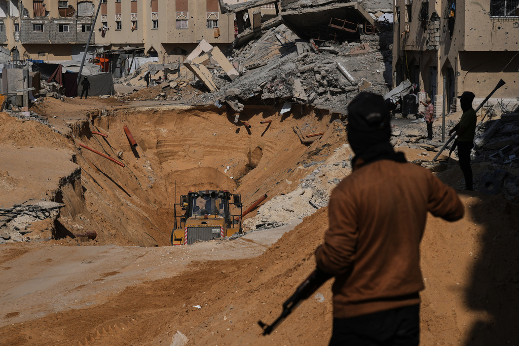 Members of the Hamas militant group search underground for the bodies of Israeli hostages amid destroyed buildings in Khan Younis, in the southern Gaza Strip.