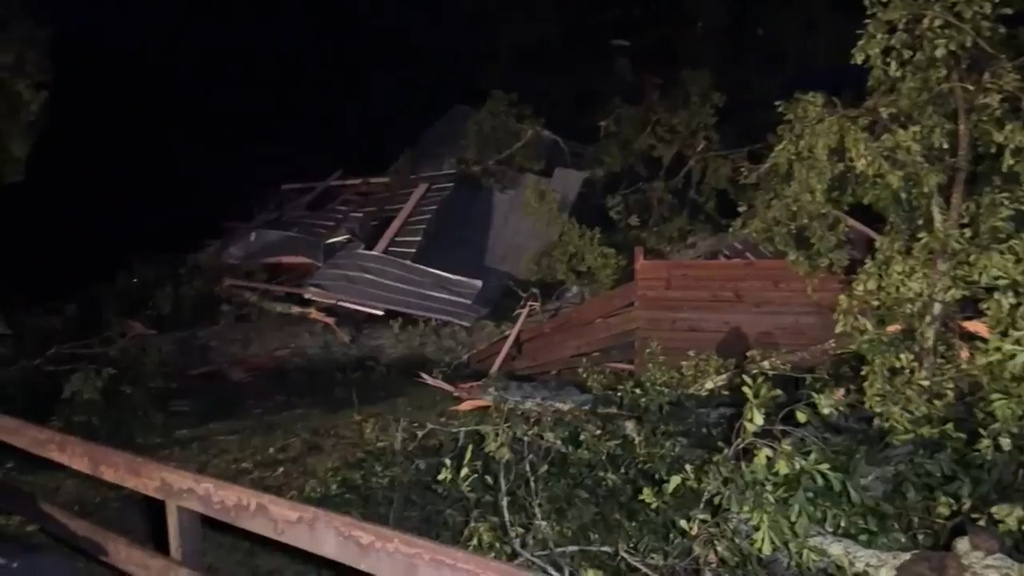 In this frame grab from video taken by WDAM, damaged trees and a house or structure following a storm that tore through part of Lamar County, Mississippi, Wednesday, May 6, 2026. 