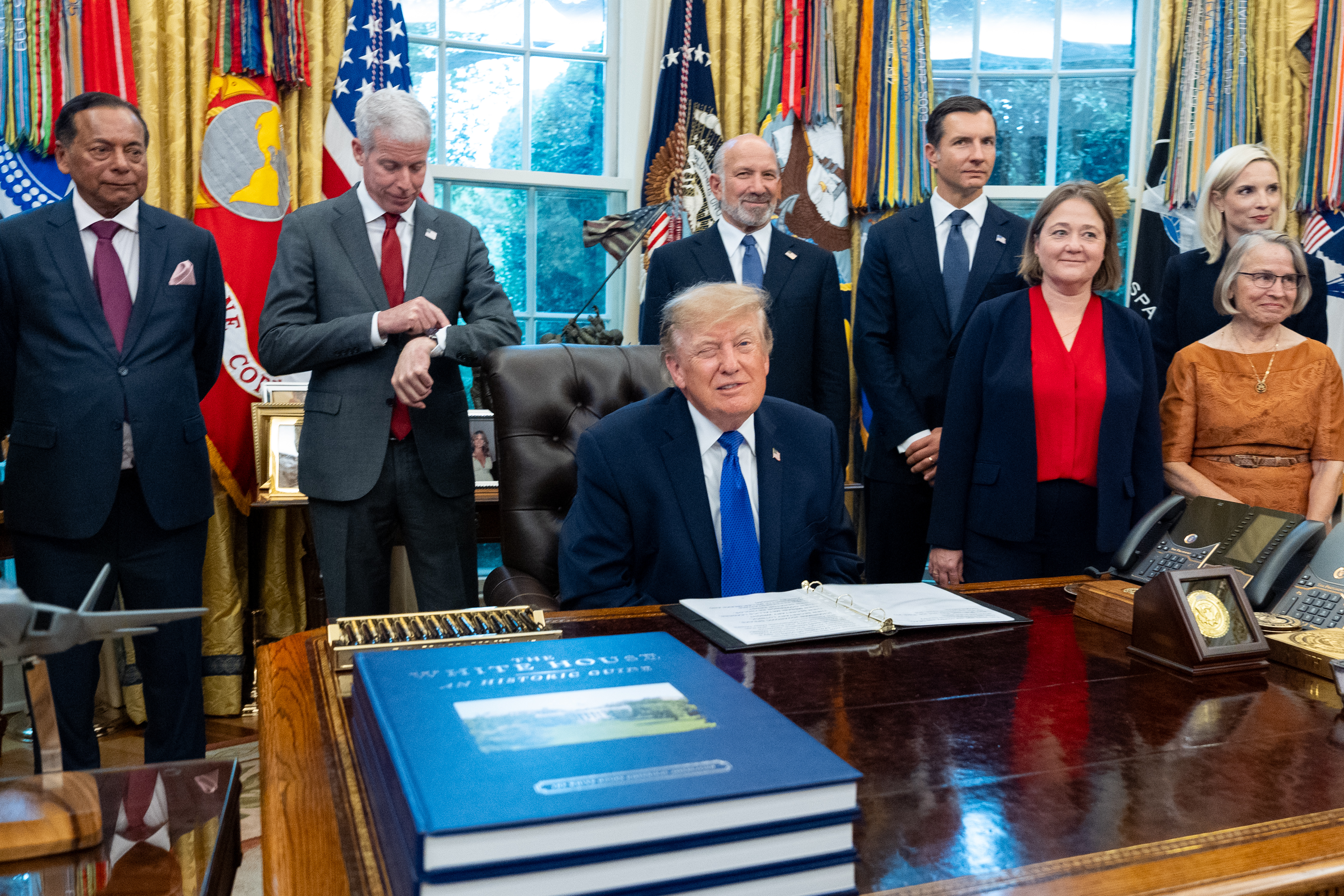 President Donald Trump winks as the members of the media depart the Oval Office of the White House as Essar Capital Director Prashant Ruia, from left, Energy Secretary Chris Wright, Commerce Secretary Howard Lutnick, John Jovanovic, chairman of the Export-Import Bank of the United States,  Iowa Attorney General Brenna Bird, Mariannette Miller-Meeks, R-Iowa., and Rep. Ashley Hinson, R-Iowa, look on, Monday, Sept. 28, 2026, in Washington. 