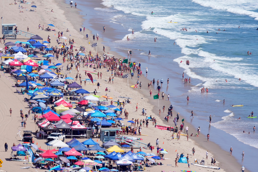 Beach goers watch during the the 46th Annual California Surf Lifesaving Championships on Will Rogers State Beach Friday, July 24, 2026, in the Pacific Palisades section of Los Angeles. 