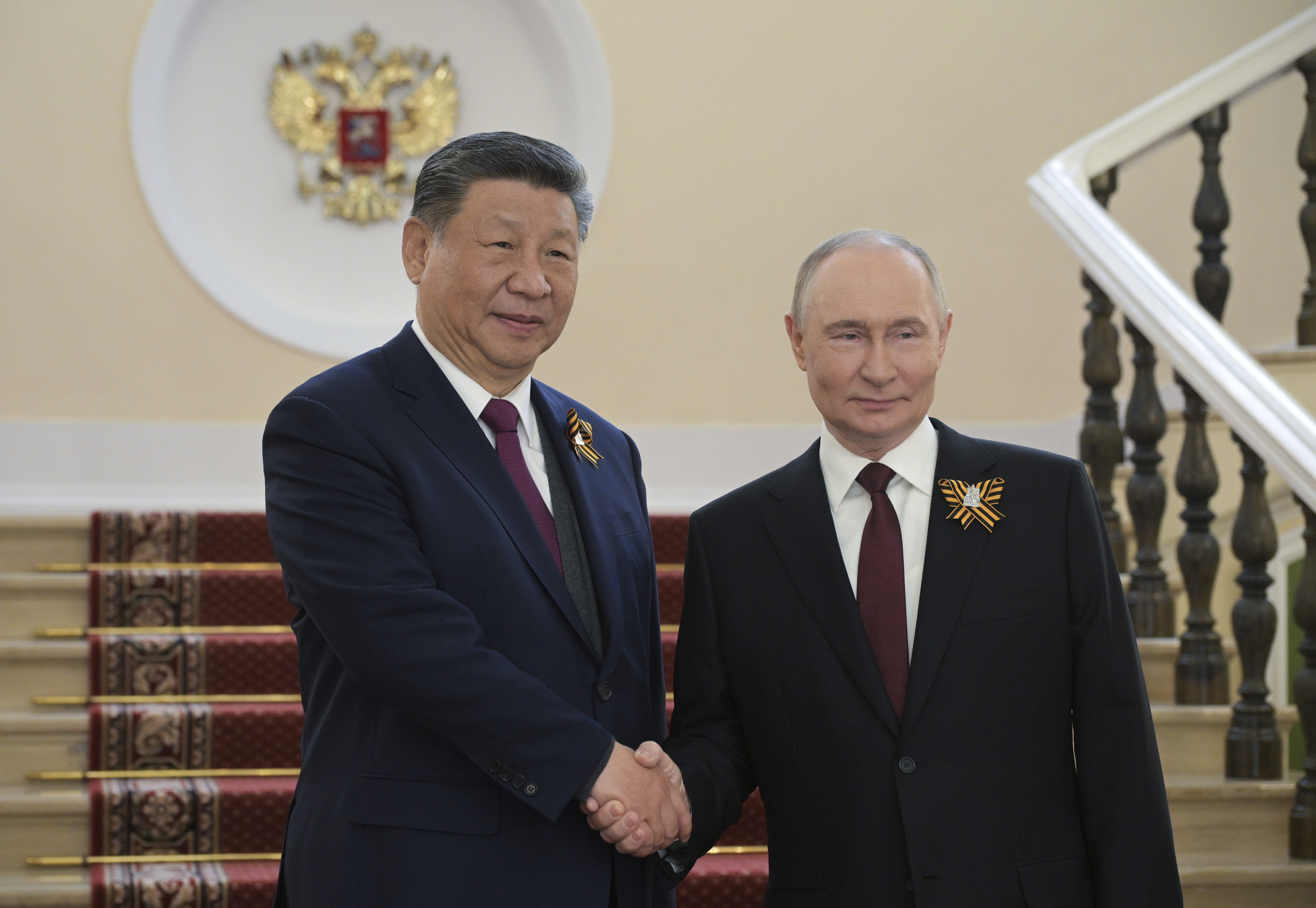 Chinese President Xi Jinping, left, and Russian President Vladimir Putin shake hands during their meeting before the Victory Day military parade in Moscow, Russia, Friday, May 9, 2025, during celebrations of the 80th anniversary of the Soviet Union's victory over Nazi Germany during the World War II. 